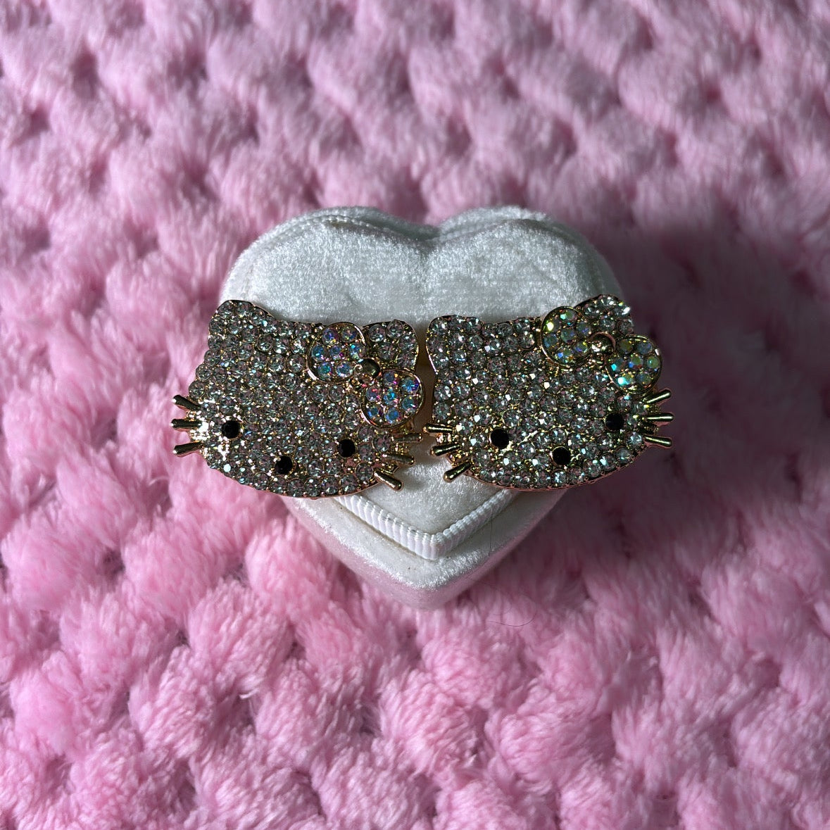 Decorative headband with intricate design on a pink textured surface